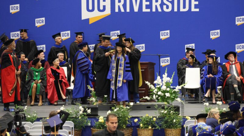 Li Yang being hooded at UCR’s 2026 Graduate Division Hooding Ceremony